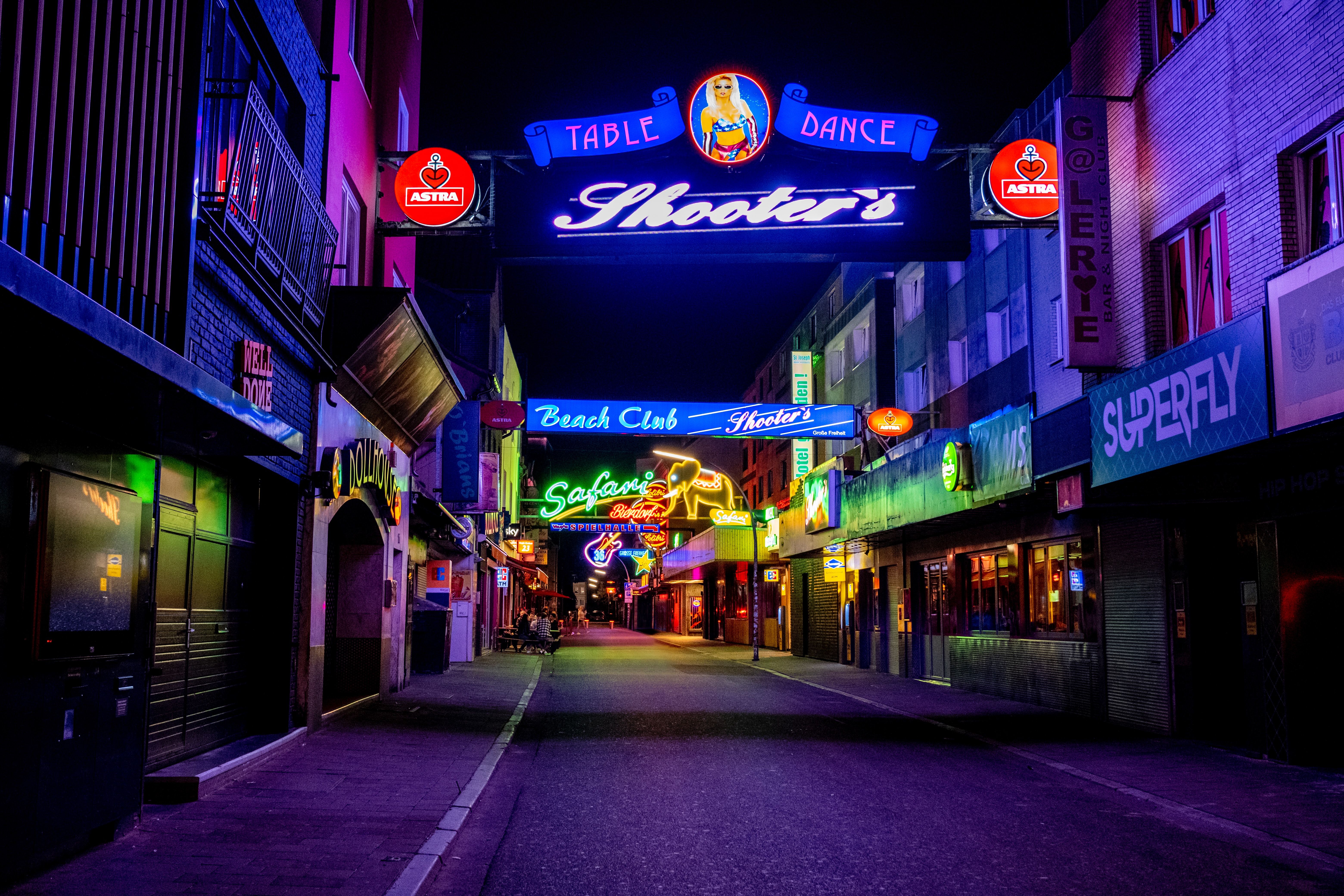 Neon-lit Reeperbahn street in Hamburg, a lively hub for nightlife and entertainment.